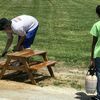 Blaine Shaw and Samuel Wilson work on the picnic tables.