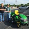 Lon Frieden, right, was the lucky winner of the John Deere lawnmower and cart that was given away during Legacy Farm and Lawn's 60th anniversary celebration on Wednesday, May 25. Although the day got off to a rough start weatherize, it turned out to be a great day for the celebration.