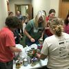 Learn A Do 4-H Club Leader Kim Ball helps members organize donations as they collect food for the Mo 4-H  Missouri Drive.