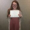 Photo courtesy of Stephen Shelton
Autumn Shelton holds up her certificate for winning the Bronze Award and being published in the Crowder Quill.