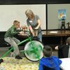 Barton County Extension NPA Teresa Dalby counted off 10 seconds as students rode the 4-H spin bike.