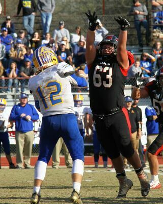 No. 63 junior defensive tackle Juan Juarez pressures the Ava quarterback in action at Thomas M. O'Sullivan Stadium. The Tigers defeated the Ava Bears to advance to the semifinals for the 10th straight year.