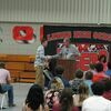 Sam Bull presented Jesse Compton with a $1,000 Grinnell Mutual Road to Success scholarship during the Lamar High School awards assembly held May 12, in the Lamar High School gym.