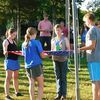 4-H counselors help campers learn more about folding the flag with respect.
