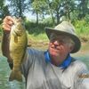 Long-time river guide Dennis Whiteside is pictured with a smallmouth from an Ozark stream.