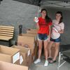 Cyan Rea, left, and Elise Ferris, right, show some of the school items that were donated for Stuff the Bus, held Saturday, Aug. 12.