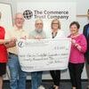 Commerce Trust Vice President Jill Reynolds, left, and CFO Board Chair Rob Foster, far right, present the grant to Chris Elswick, Wayne Johnston, Nancy Curless and Judy Rice.
