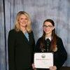 Missouri Department of Agriculture Director Chris Chinn, left, presents Megan Schlichting of the Lamar FFA Chapter with the Building Our American Communities Grant.