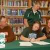 Lamar Democrat/Melody Metzger
Pictured with Lexie Royster (center) as she signs a letter of intent to play basketball at Central Methodist University are her parents, seated, left, Ted Clements and right, Casey Royster Clements. Jessie Arnold, an assistant coach with Central Methodist is standing.