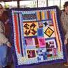 Photo courtesy of Willis Strong
Pictured holding the quilt designed by Lauryn Davis are, Lendi Davis, left, and Barbara McDaniel, right. The quilt was displayed at the 10th Street Community Farmers' Market, where both ladies are involved.