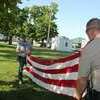 Photo courtesy of Willis Strong
Mike Gebelin and Barton County Sheriff John Simpson fold the American Flag during the annual Flag Retirement Ceremony held at the South City Park in Liberal.